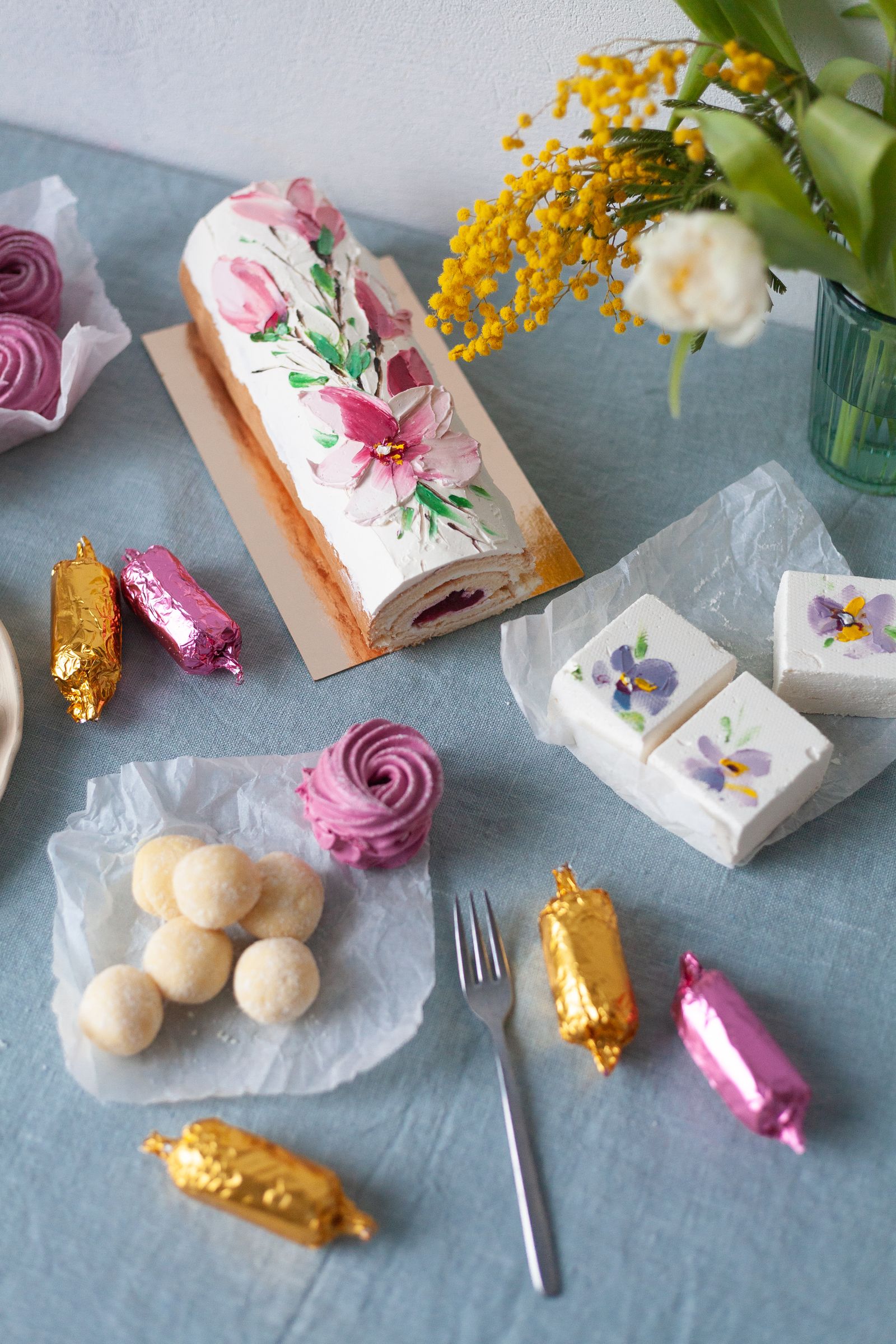 Cakes and sweets arranged on a blue table